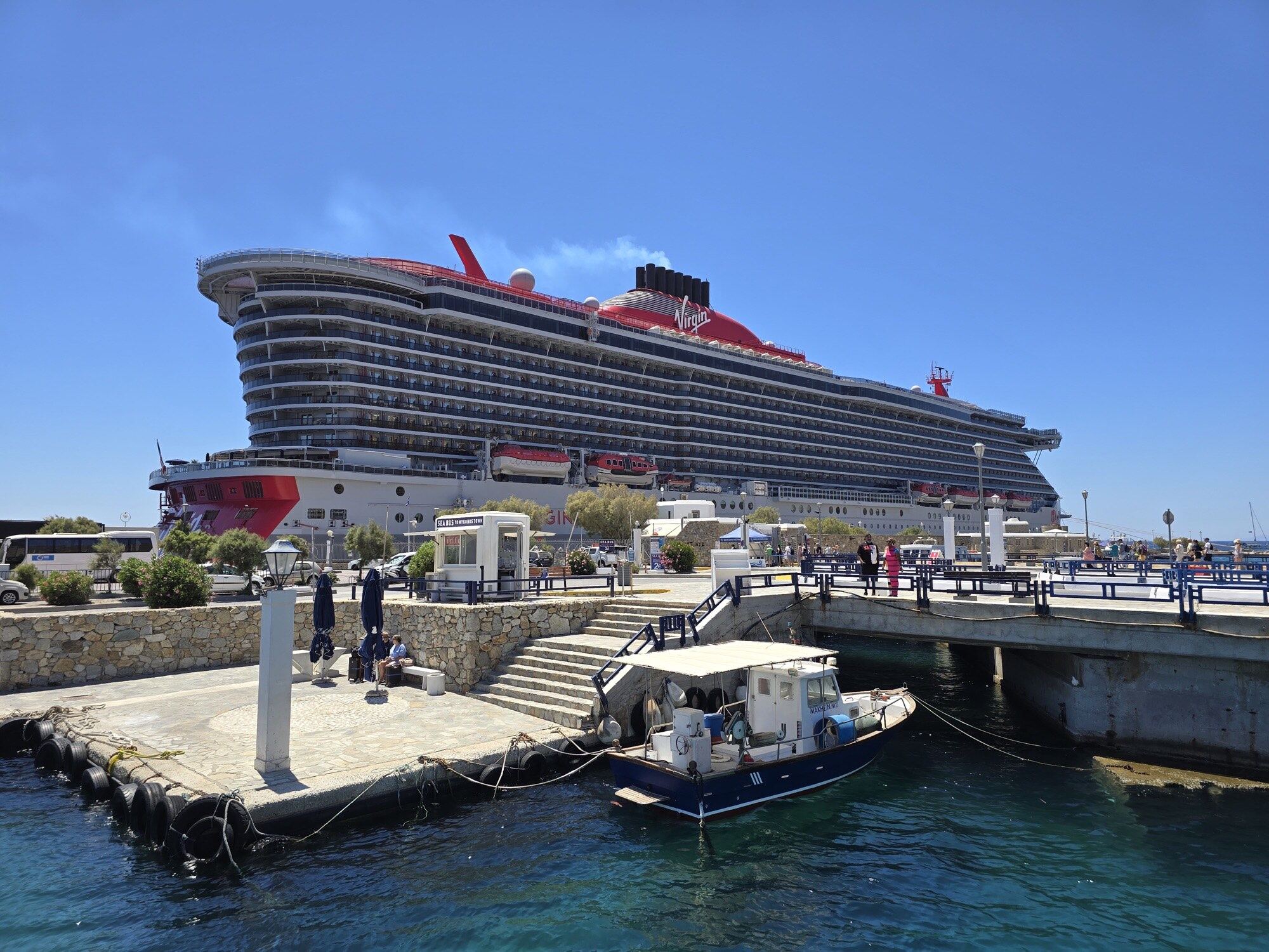A Virgin Voyages cruise ship docked at port